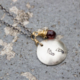 Stamped Metals Collection: Oxidized sterling silver medium stamped disc with 14K goldfill with garnet